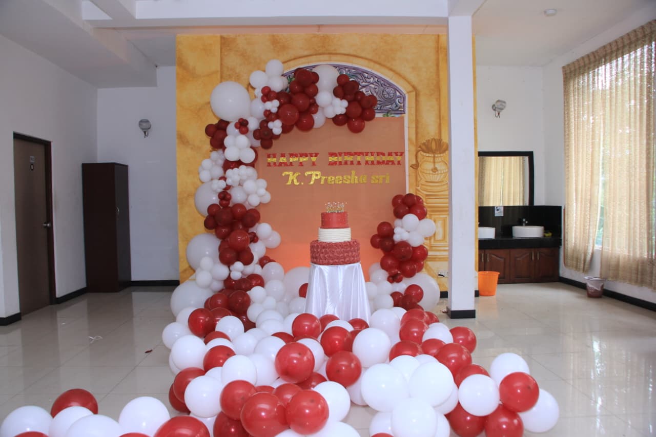 K. Preesha Sri birthday setup with red and white balloons